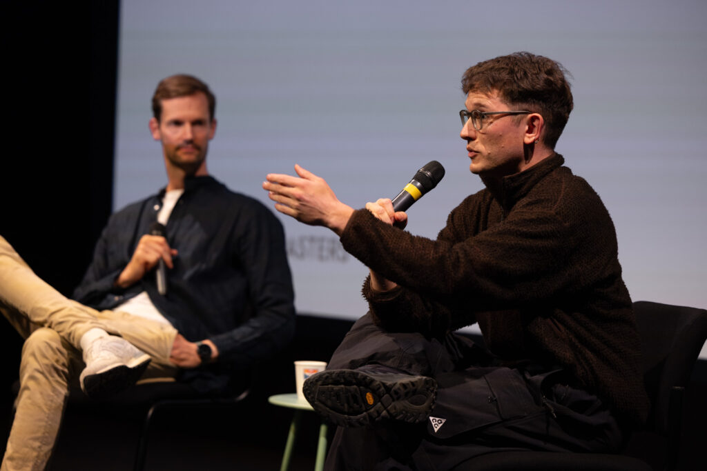 Ted speaking during the keynote while Max listens.